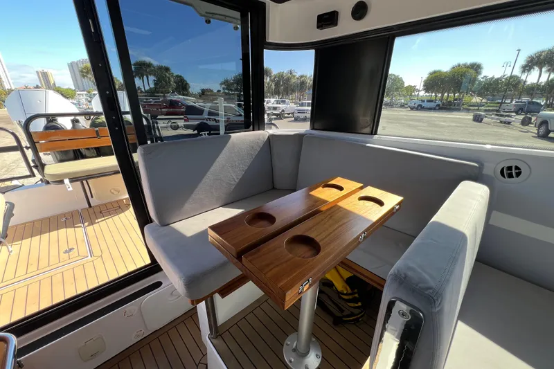 Slide: The Image of Interior of 2024 XO Boats EXPLR 10 S Plus with seating and wooden table. - 39