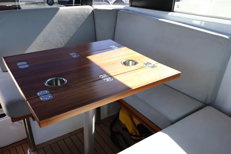 Slide: The Image of Interior seating area of 2024 XO Boats EXPLR 10 S Plus with wooden table. - 40