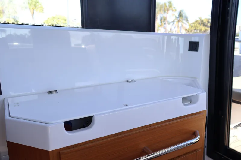 Slide: The Image of Interior detail of 2024 XO Boats EXPLR 10 S Plus, featuring sleek cabinetry design. - 42