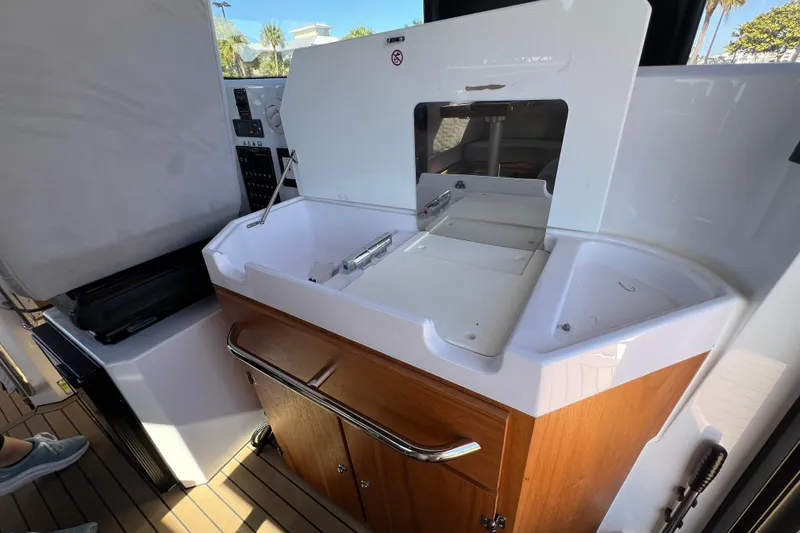Slide: The Image of 2024 XO Boats EXPLR 10 S Plus interior with sink and storage cabinet. - 43