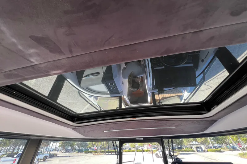 Slide: The Image of Interior view of 2024 XO Boats EXPLR 10 S Plus with sunroof and dashboard reflection. - 44