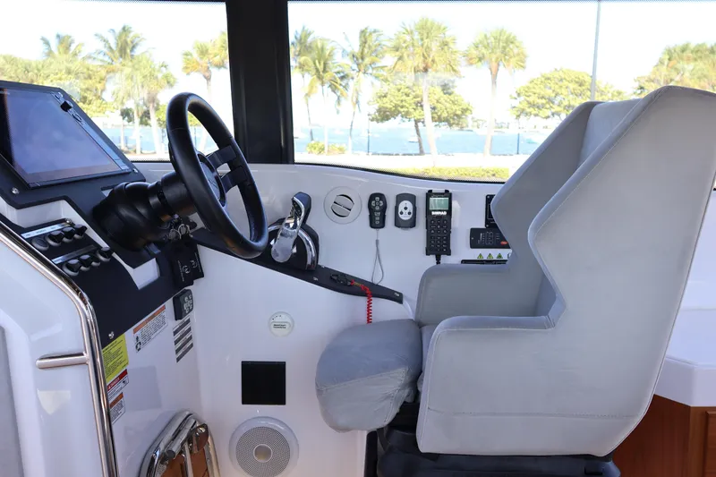 Slide: The Image of 2024 XO Boats EXPLR 10 S Plus helm with steering wheel and control panel. - 45