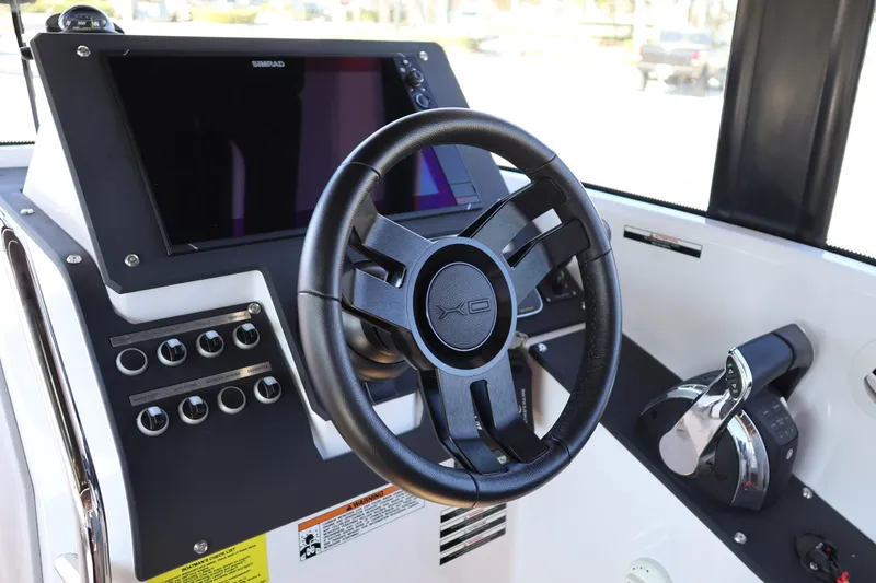 Slide: The Image of 2024 XO Boats EXPLR 10 S Plus helm with steering wheel and control panel. - 46