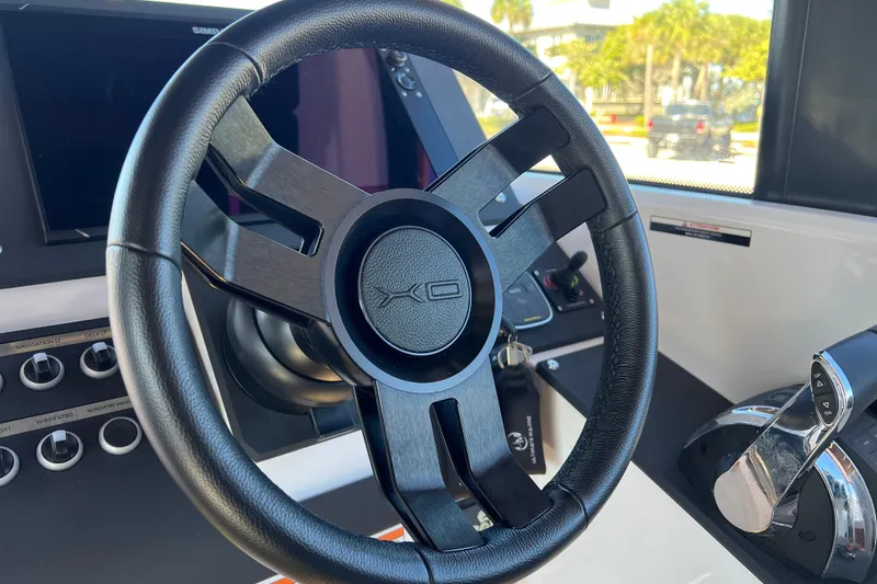 Slide: The Image of 2024 XO Boats EXPLR 10 S Plus steering wheel and control panel. - 47