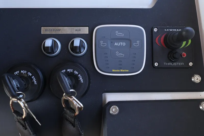 Slide: The Image of Control panel of 2024 XO Boats EXPLR 10 S Plus with switches and thruster joystick. - 54