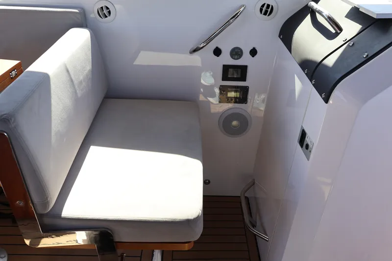 Slide: The Image of 2024 XO Boats EXPLR 10 S Plus interior seating and control panel. - 57