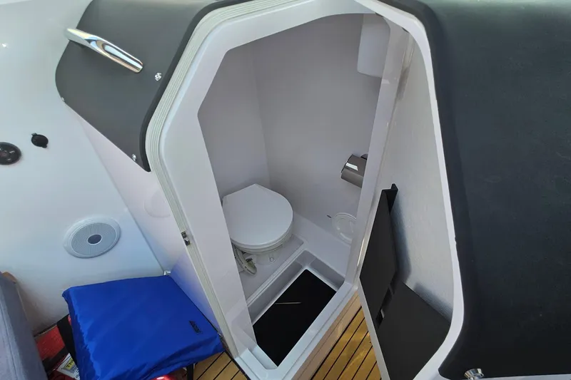 Slide: The Image of 2024 XO Boats EXPLR 10 S Plus interior bathroom with modern design and compact toilet. - 58