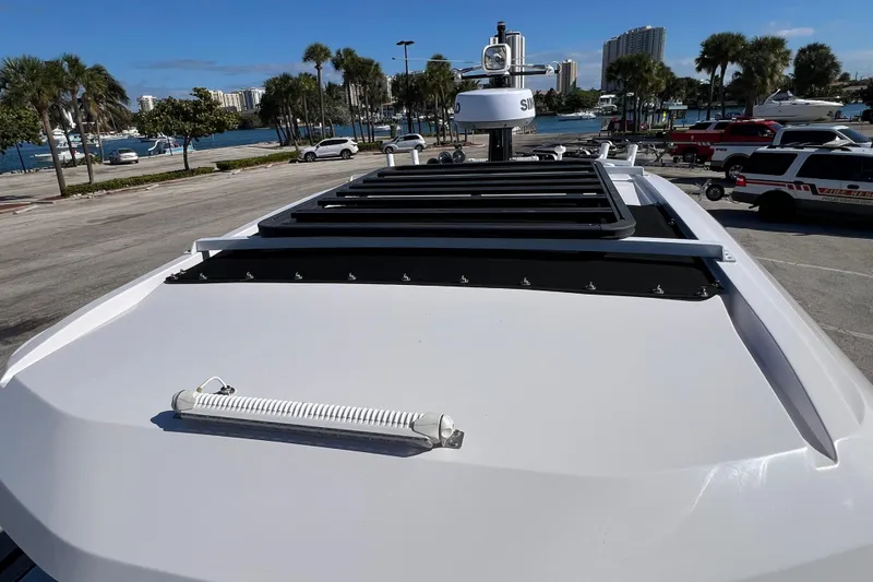 Slide: The Image of 2024 XO Boats EXPLR 10 S Plus roof view with coastal background. - 65