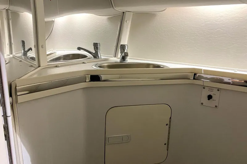 Slide: The Image of 2004 Fountain 38 Lightning boat interior with sink and head pump controls. - 15