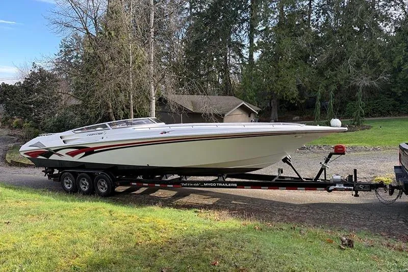 Slide: The Image of 2004 Fountain 38 Lightning speedboat on trailer in a wooded area. - 2
