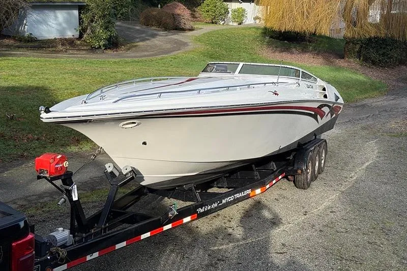 Slide: The Image of 2004 Fountain 38 Lightning boat on trailer in a residential driveway. - 3