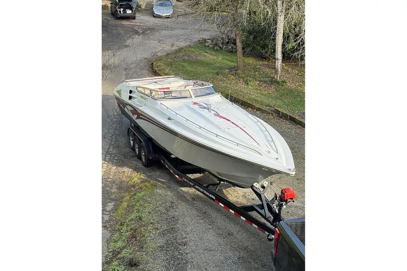 Slide: The Image of 2004 Fountain 38 Lightning boat on trailer in driveway setting. - 4