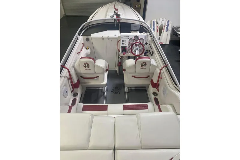 Slide: The Image of 2004 Fountain 38 Lightning boat interior with white and red seating, detailed dashboard. - 6