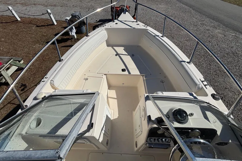 Slide: The Image of Key West 2020 Dual Console boat, 2004 model, featuring spacious seating and steering console. - 14