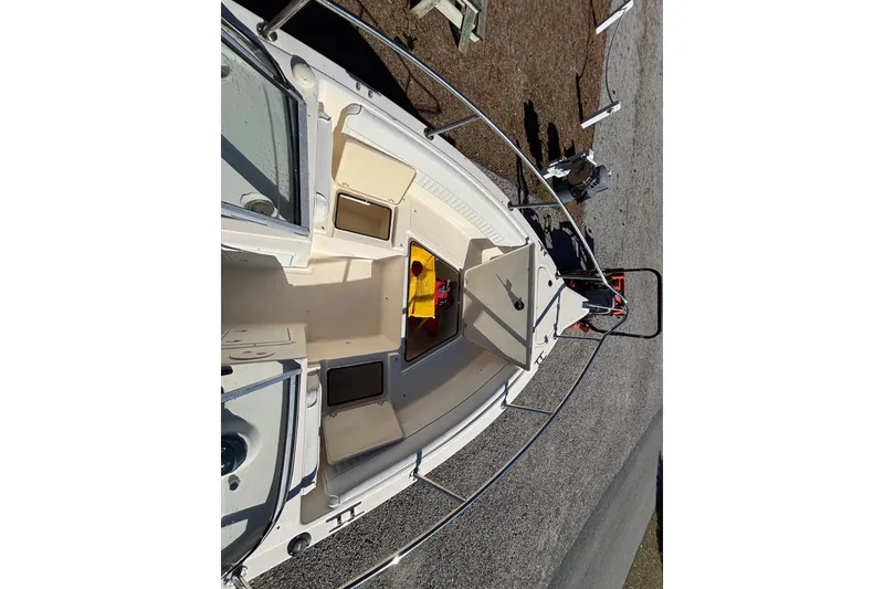 Slide: The Image of 2004 Key West 2020 Dual Console boat interior with storage compartments and seating. - 15