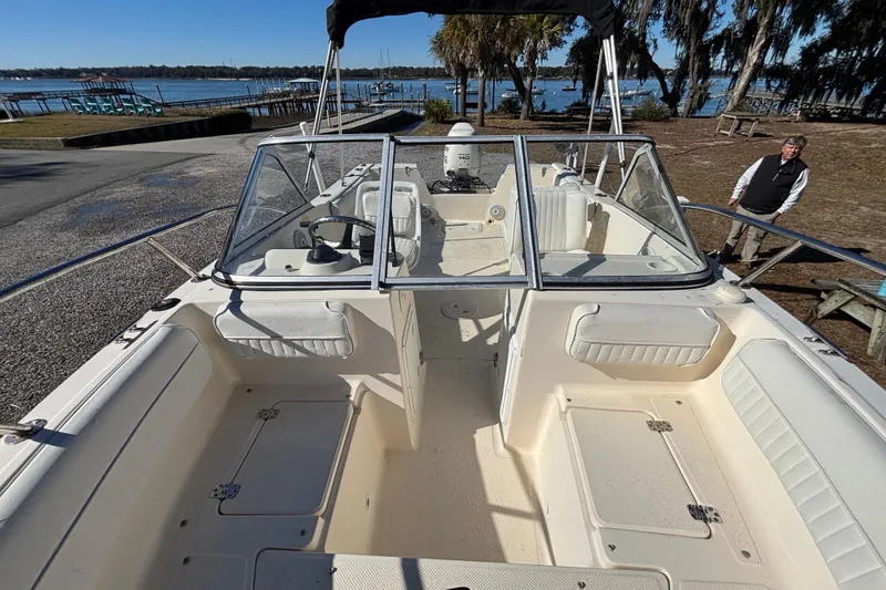 Slide: The Image of Key West 2020 Dual Console boat, 2004 model, docked near a scenic waterfront. - 21
