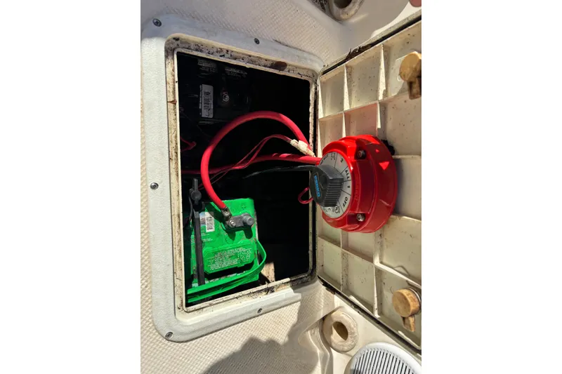Slide: The Image of Battery compartment of 2004 Key West 2020 Dual Console boat with red switch. - 25