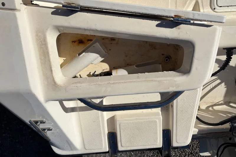Slide: The Image of Open storage compartment on a 2004 Key West 2020 Dual Console boat. - 26