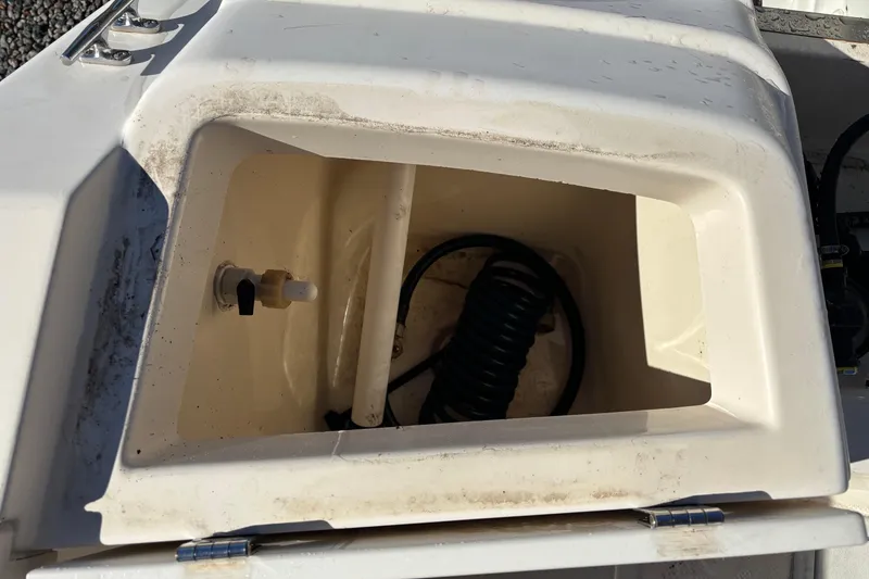 Slide: The Image of Open storage compartment on a 2004 Key West 2020 Dual Console boat. - 28