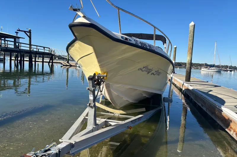 Slide: The Image of Key West 2020 Dual Console boat on trailer at marina, sunny day. - 3