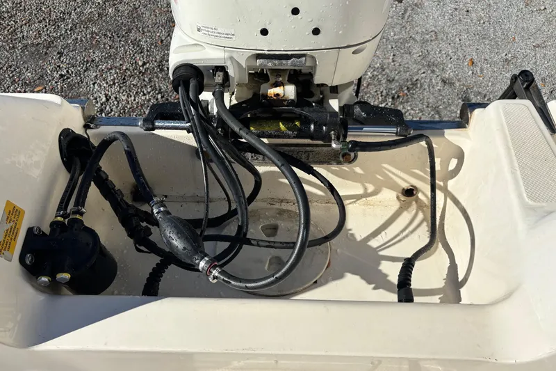 Slide: The Image of Key West 2020 Dual Console boat engine compartment with cables and hydraulic components. - 5