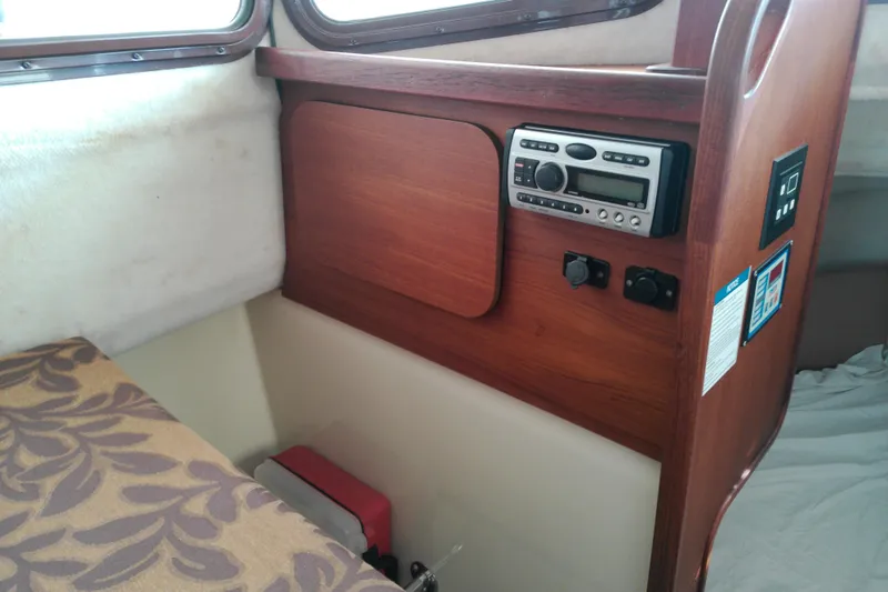 Slide: The Image of 2010 Ranger Tugs R-25 interior with wood paneling and audio system. - 13
