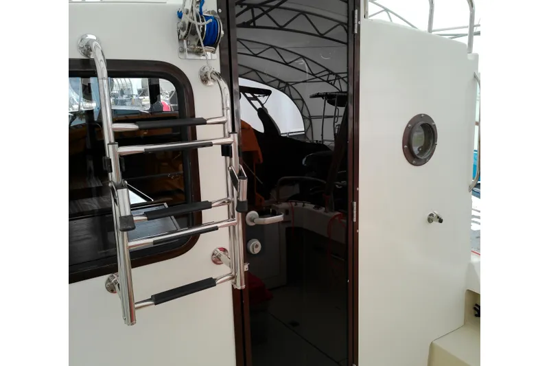 Slide: The Image of 2010 Ranger Tugs R-25 boat interior with ladder and porthole view. - 2