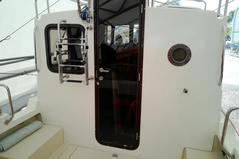 Slide: The Image of 2010 Ranger Tugs R-25 boat cabin entrance with ladder and porthole. - 24