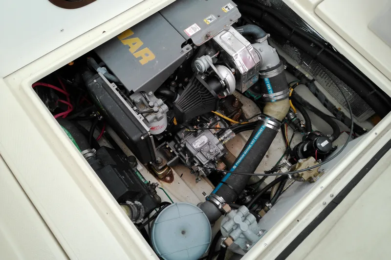 Slide: The Image of Engine compartment of a 2010 Ranger Tugs R-25 boat, showcasing mechanical components. - 25