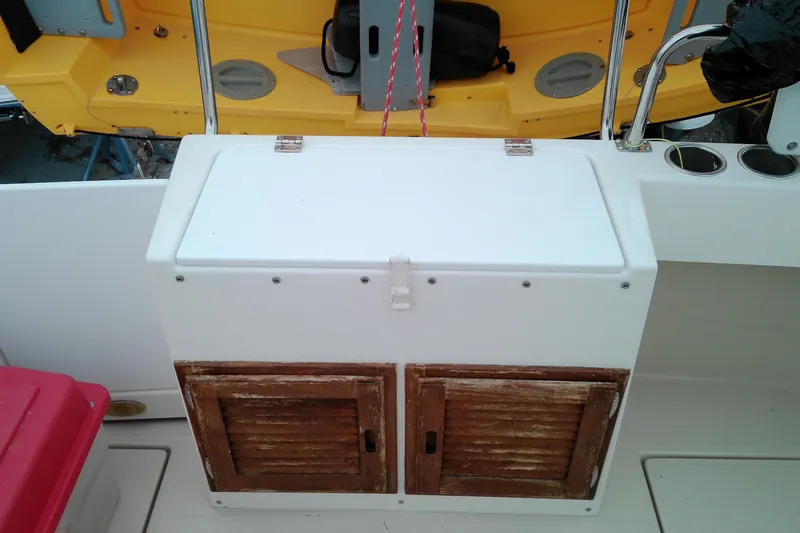 Slide: The Image of 2010 Ranger Tugs R-25 boat interior with storage compartment and cup holders. - 28