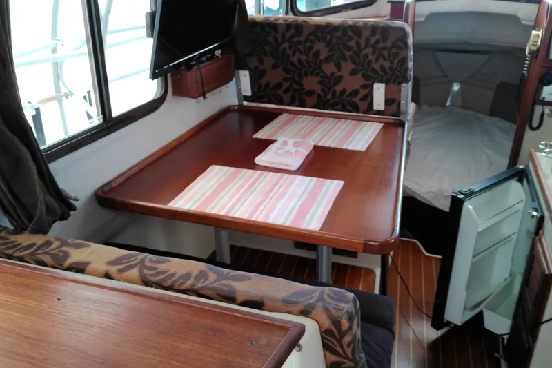 Slide: The Image of Interior of 2010 Ranger Tugs R-25 with dining area and cozy cabin space. - 29
