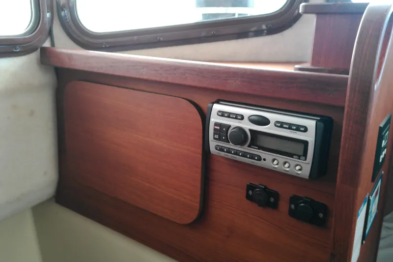 Slide: The Image of Interior of 2010 Ranger Tugs R-25 boat with wooden paneling and stereo system. - 36