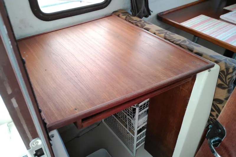 Slide: The Image of Interior of 2010 Ranger Tugs R-25 with wooden table and storage baskets. - 37