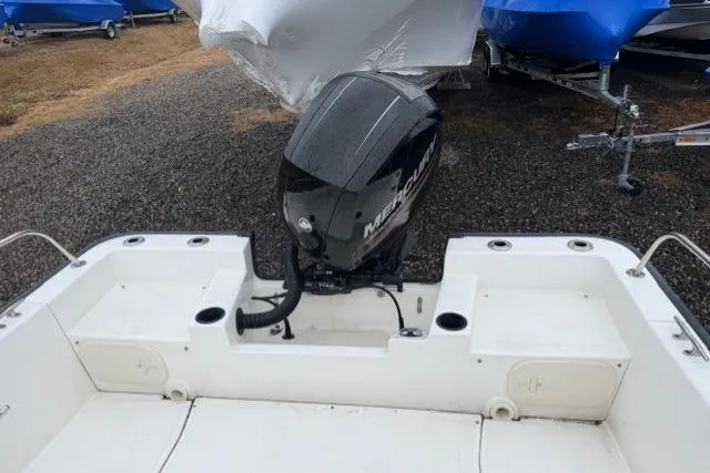 Slide: The Image of 2017 Boston Whaler 190 Montauk boat with Mercury outboard motor, parked on gravel. - 13