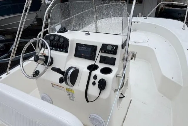 Slide: The Image of 2017 Boston Whaler 190 Montauk boat console with steering wheel and navigation controls. - 6