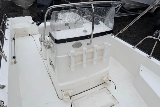 Slide: The Image of 2017 Boston Whaler 190 Montauk boat interior with steering console and rod holders. - 8