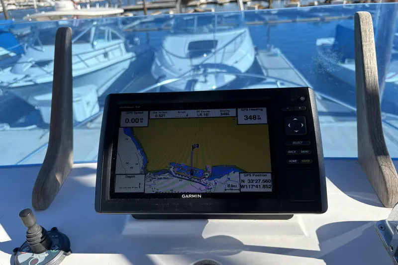 Slide: The Image of Garmin GPS on 1972 Gandy Flybridge boat, docked with other vessels in background. - 10