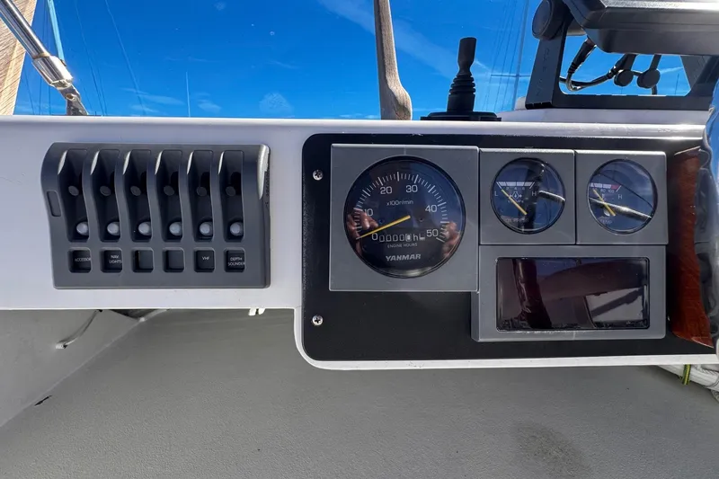 Slide: The Image of Control panel of a 1972 Gandy Flybridge boat with gauges and switches. - 11