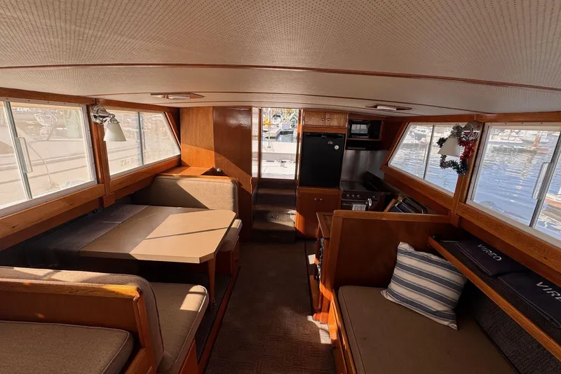 Slide: The Image of Interior of a 1972 Gandy Flybridge boat with cozy seating and wood accents. - 14