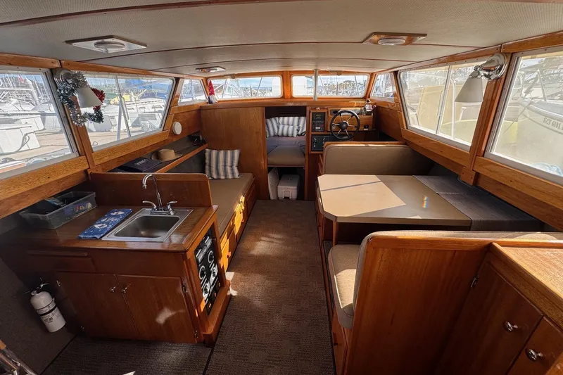 Slide: The Image of Interior of a 1972 Gandy Flybridge boat with wood finish and cozy seating area. - 15