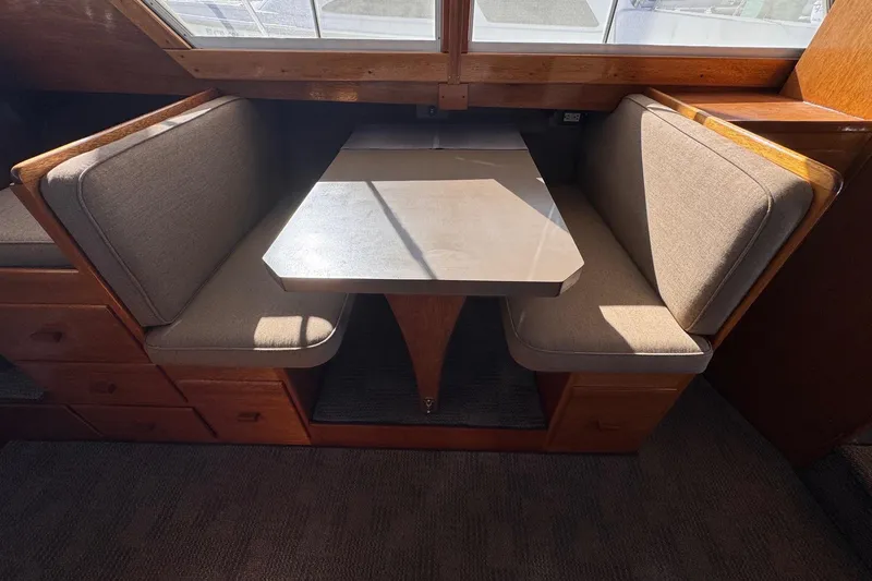 Slide: The Image of Interior view of a 1972 Grandy Flybridge boat with dining table. - 21