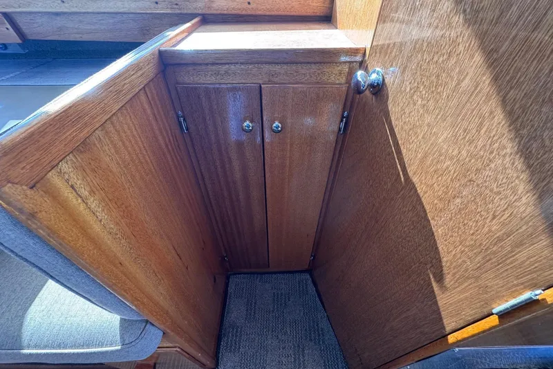 Slide: The Image of 1972 Gandy Flybridge wooden cabinet interior with carpeted floor and sunlight. - 24