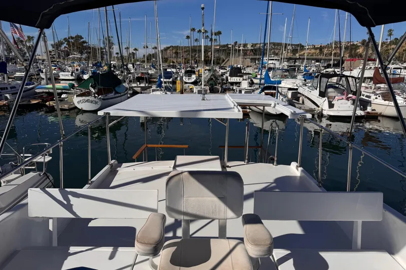 Slide: The Image of 1972 Gandy Flybridge boat docked in a marina with numerous other vessels. - 6