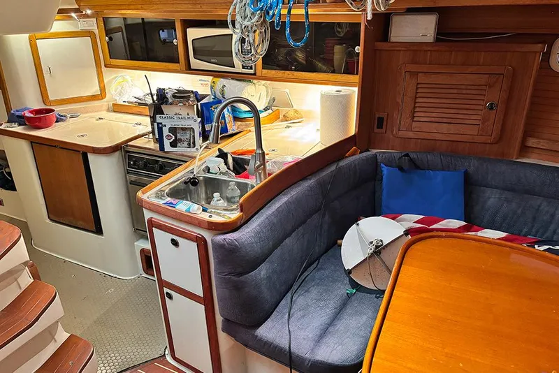 Slide: The Image of Interior of a 1999 Catalina 42 MkII sailboat with kitchen and seating area. - 11