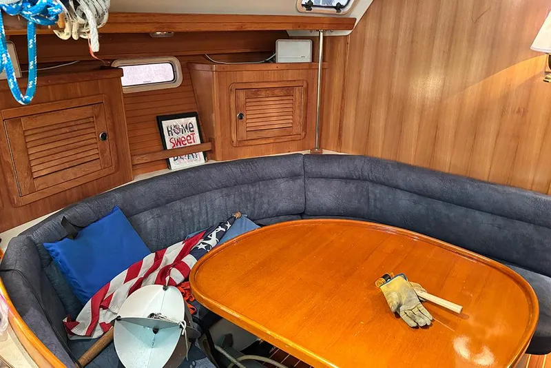 Slide: The Image of Cozy interior of 1999 Catalina 42 MkII sailboat with wooden table and seating. - 12