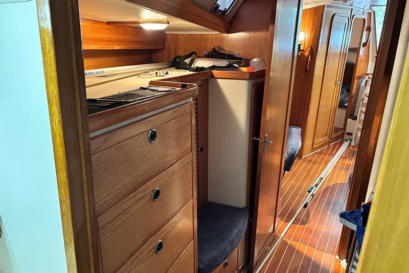 Slide: The Image of Interior of 1999 Catalina 42 MkII sailboat with wooden cabinetry and cozy seating. - 16