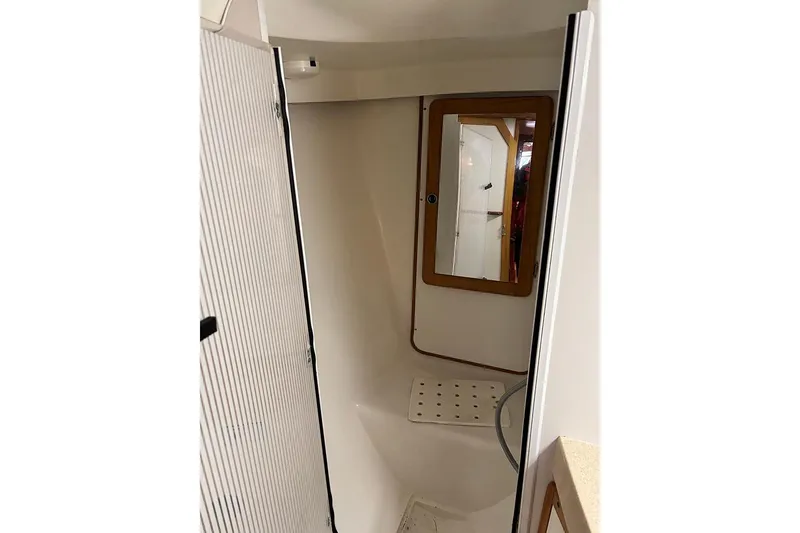 Slide: The Image of Interior of 1999 Catalina 42 MkII sailboat bathroom with mirror and shower area. - 17