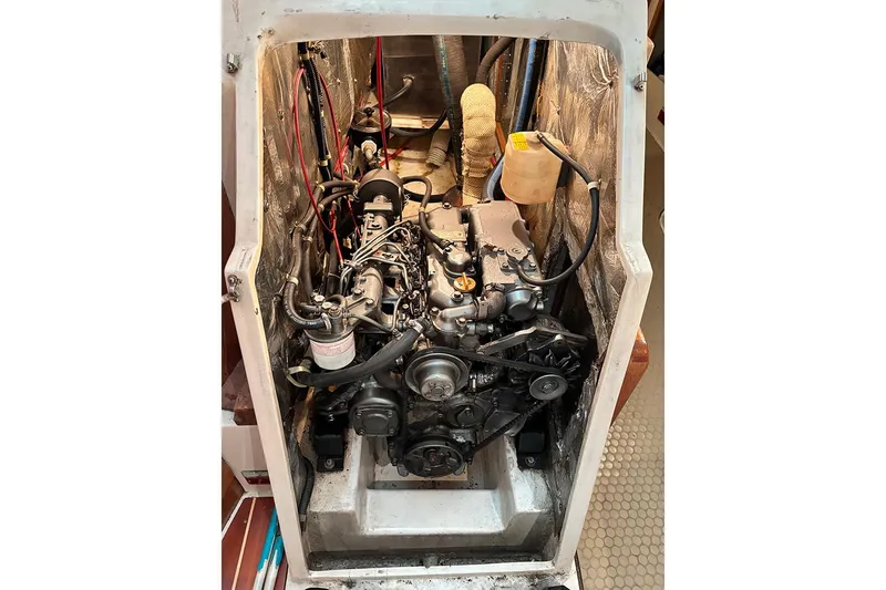 Slide: The Image of Engine compartment of a 1999 Catalina 42 MkII sailboat, showcasing mechanical components. - 19
