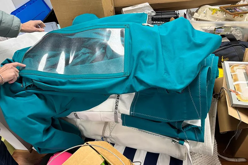 Slide: The Image of Teal sail cover for 1999 Catalina 42 MkII, folded on a cluttered surface. - 28