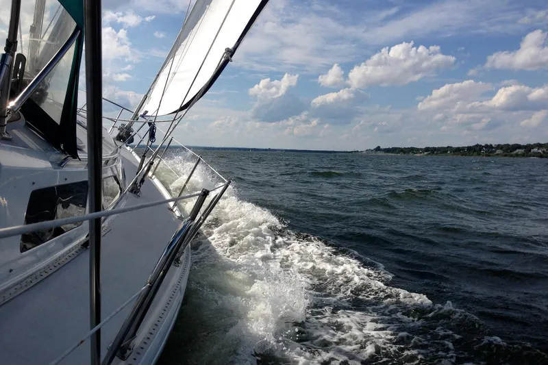 Slide: The Image of Sailing on a 1999 Catalina 42 MkII yacht under a partly cloudy sky. - 4